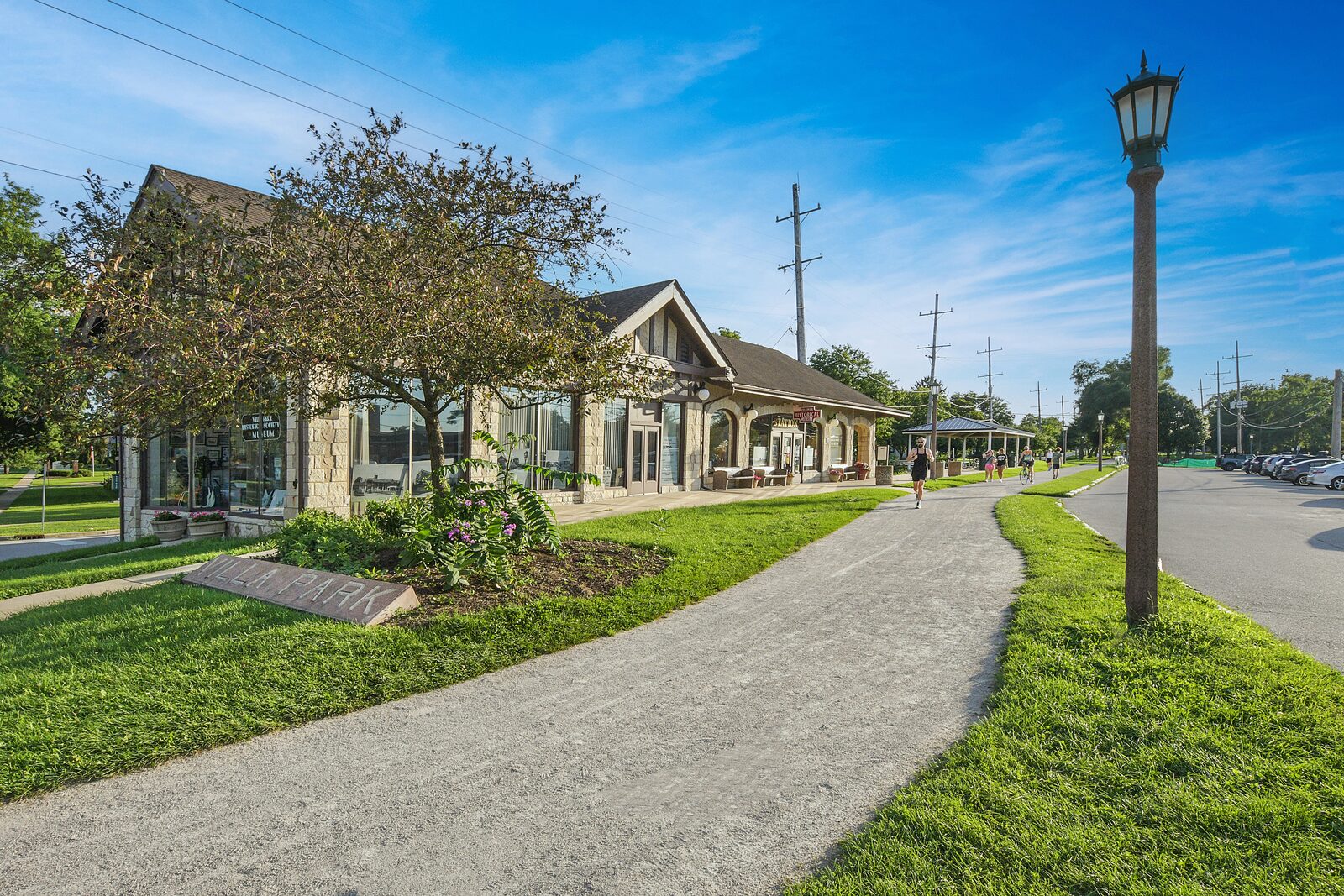 A walking path through a downtown Villa Park park